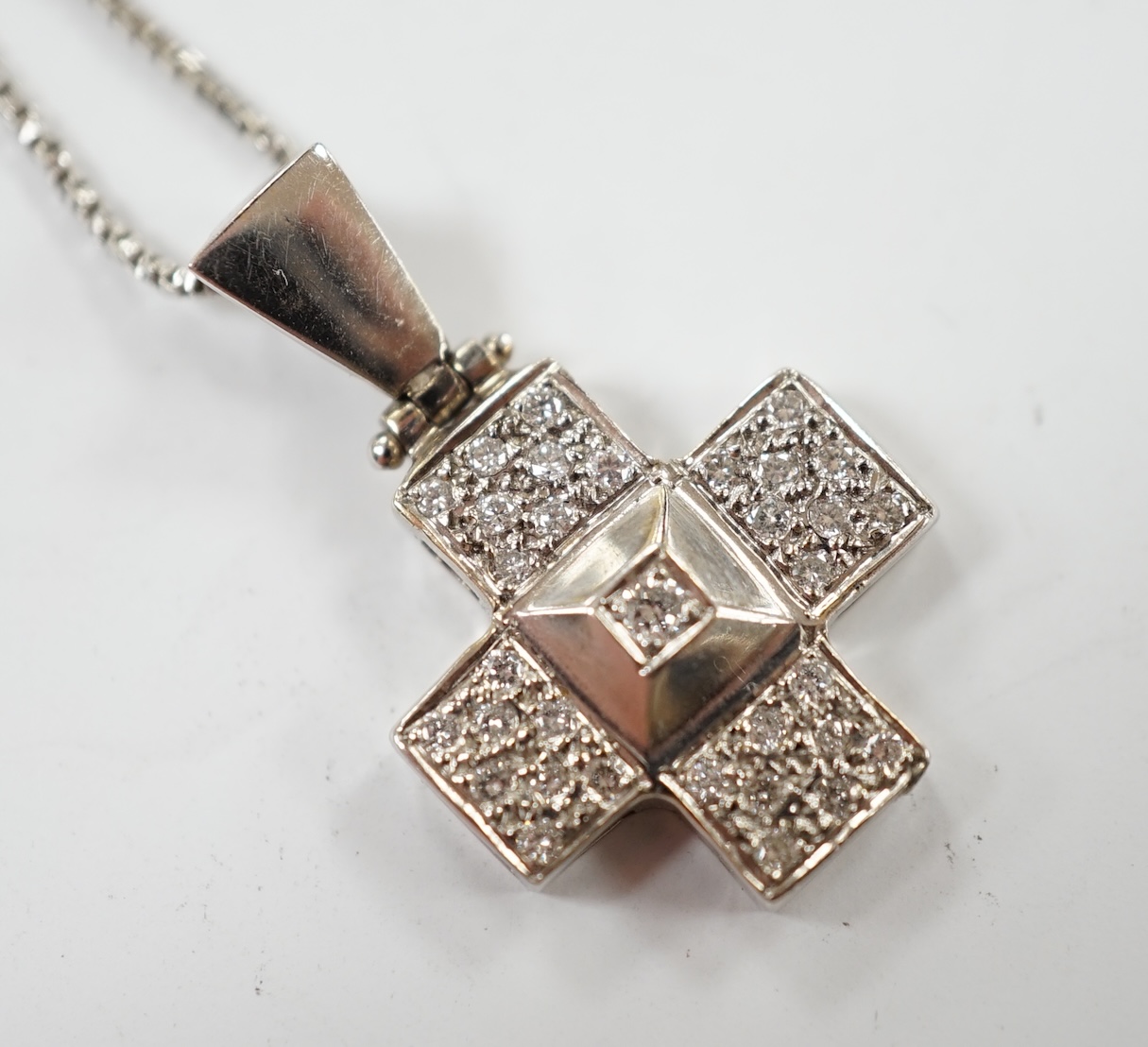 A modern 18ct white gold and diamond cluster set cross pendant, overall 25mm, on an 18ct white gold fine link chain, 40cm, gross weight 6.1 grams. Condition - good